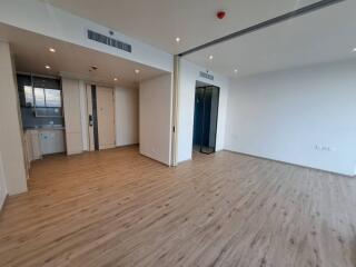 Spacious living room with wooden flooring and natural light