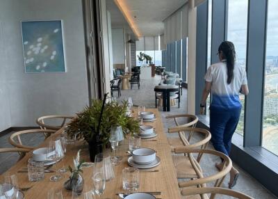 Modern dining area with a large table, window views, and contemporary decor