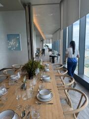 Modern dining area with a large table, window views, and contemporary decor