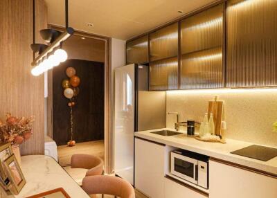 Modern kitchen with dining area, marble countertop, laptop, and decorative elements