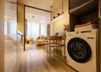 Modern living area with a washer and dining table