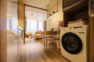 Modern living area with a washer and dining table