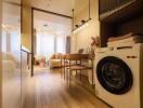 Modern living area with a washer and dining table