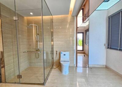 Modern bathroom with glass shower enclosure and toilet