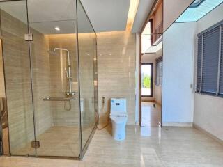 Modern bathroom with glass shower enclosure and toilet