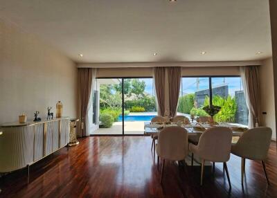 Modern living room with dining area and view of the pool