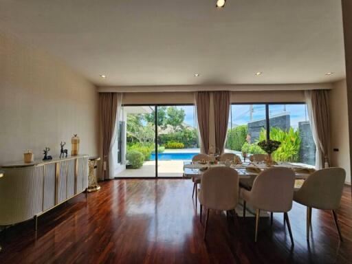 Modern living room with dining area and view of the pool