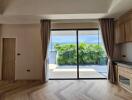 Living room with large glass doors, curtains, and a view of a garden