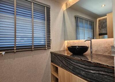 Modern bathroom with wooden vanity and black basin