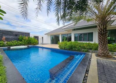 Backyard with swimming pool and palm tree