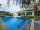 Backyard with swimming pool and palm tree