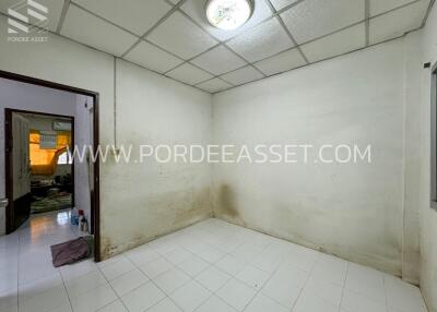 Empty bedroom with tiled floor and ceiling light