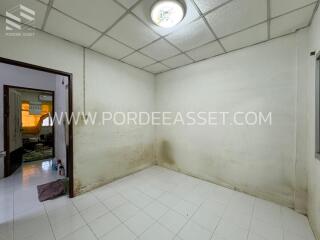 Empty bedroom with tiled floor and ceiling light