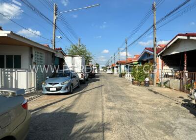 Street view of neighborhood with houses and parked cars