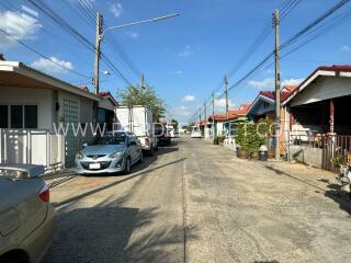 Street view of neighborhood with houses and parked cars