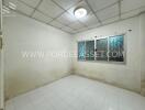 Empty room with tiled floor and window