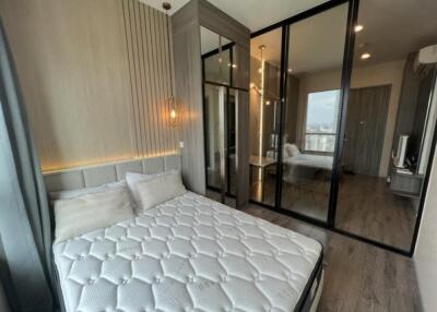 Modern bedroom with glass-paneled wardrobe and a view