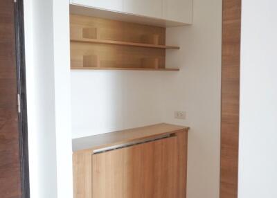 Small corner kitchen space with cabinets and shelves