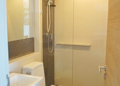 Modern bathroom with glass shower enclosure and white fixtures