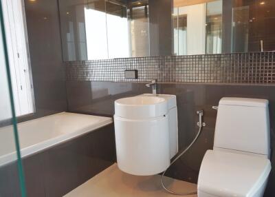 Modern bathroom with bathtub, sink, and toilet