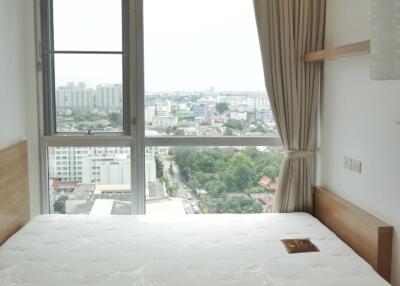 Modern bedroom with large window and city view