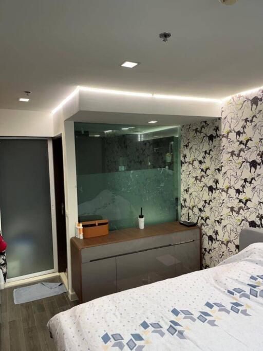 Modern bedroom with glass partition and decorative wallpaper