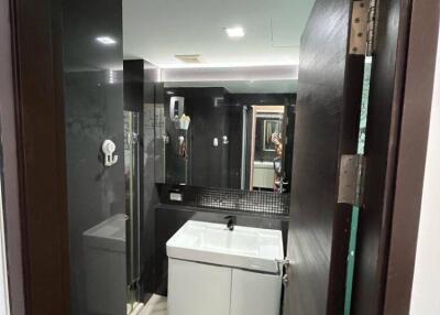 Modern bathroom with dark accents and white fixtures