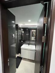 Modern bathroom with dark accents and white fixtures