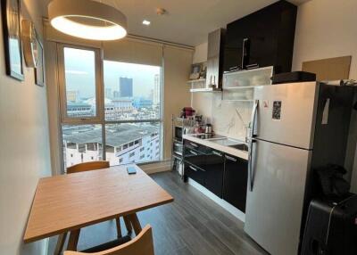 Modern kitchen with dining area and city view