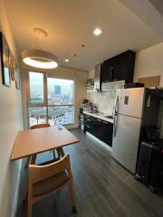 Modern kitchen with dining area and city view