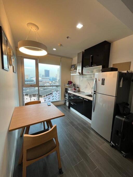 Modern kitchen with dining area and city view