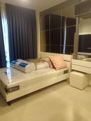 A furnished bedroom with bed and mirrored wardrobe