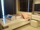 A furnished bedroom with bed and mirrored wardrobe