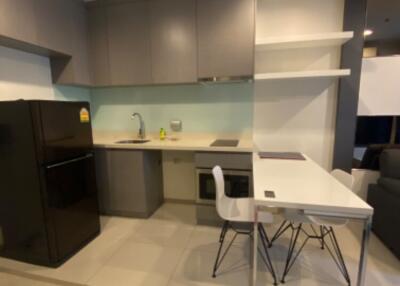 Modern kitchen area with appliances and dining space