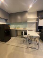 Modern kitchen area with appliances and dining space