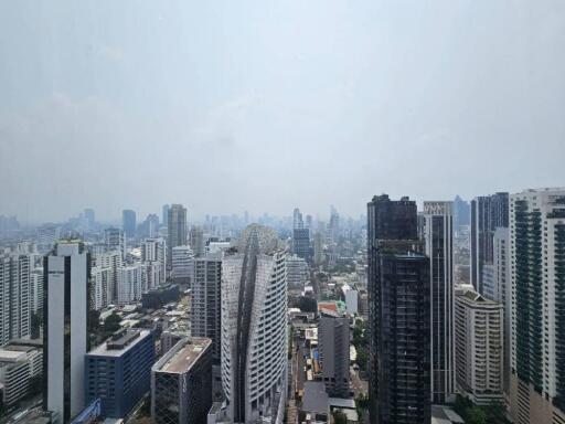 Cityscape view of tall buildings and skyscrapers under a cloudy sky