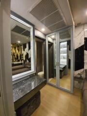 Modern bedroom with mirrored closet and marble-topped vanity area