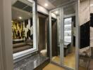 Modern bedroom with mirrored closet and marble-topped vanity area