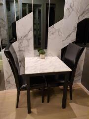 Small dining area with marble table and black chairs