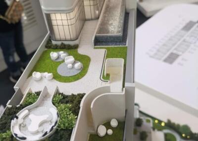 Model of a building with rooftop patio and garden