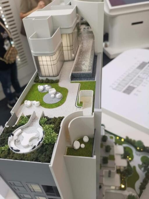 Model of a building with rooftop patio and garden