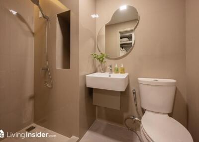 Modern bathroom with walk-in shower, sink, and toilet