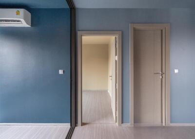 Modern bedroom with blue walls and two doors