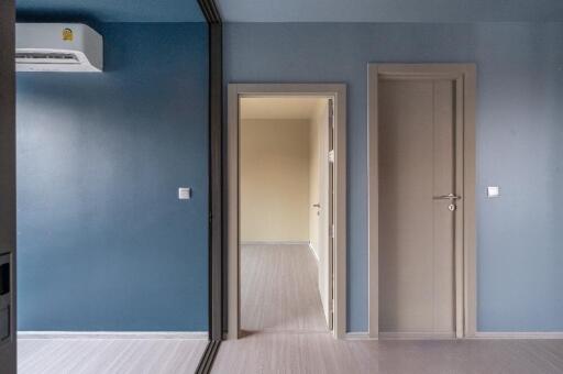 Modern bedroom with blue walls and two doors