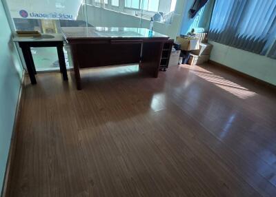 Spacious office with wooden flooring and large windows