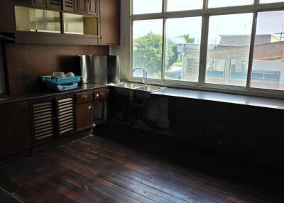 Kitchen with dark cabinetry and large windows