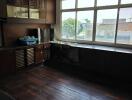 Kitchen with dark cabinetry and large windows