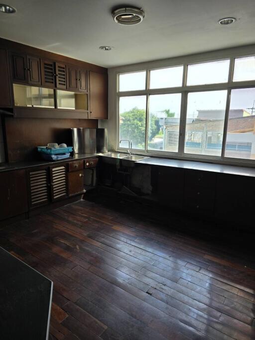 Kitchen with dark cabinetry and large windows