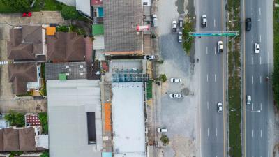 Aerial view of residential and commercial buildings alongside a major road