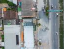 Aerial view of residential and commercial buildings alongside a major road